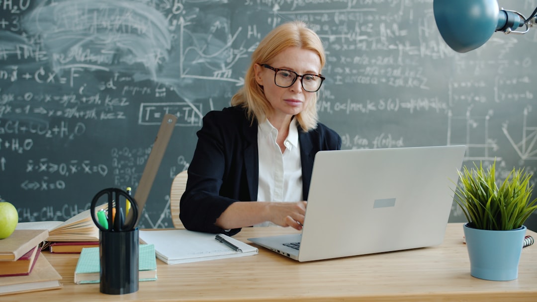 Teacher using a laptop to plan lessons with artificial intelligence
