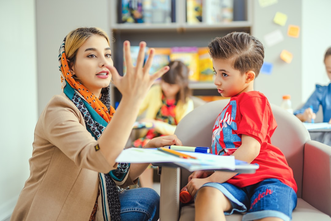 Teacher giving calm individual support to a student during a classroom activity